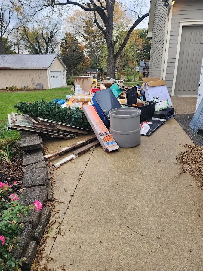 Dumpster being loaded with debris for 12 Yard Dumpster Rental in Wiscasset
